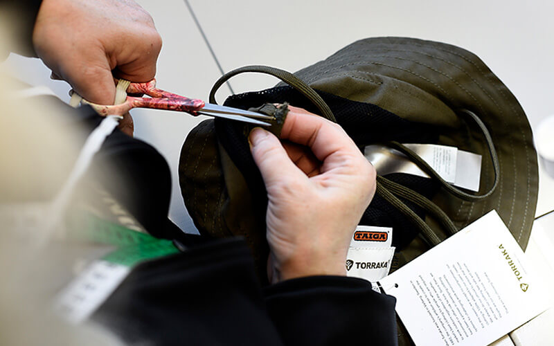 Close up image of scissors and cap from Taiga